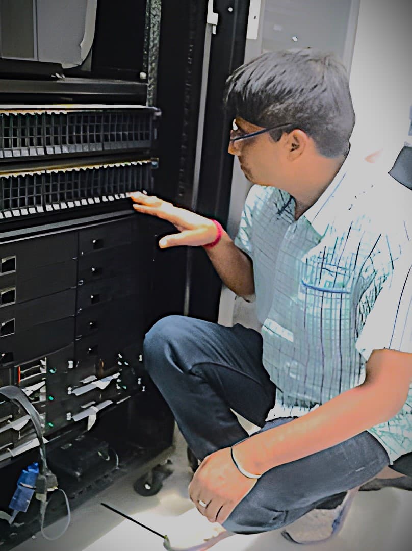 An image of Ashok (SIIS Founder) fixing a server